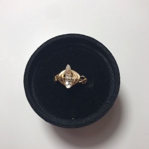 gold wore ring with clean quartz bead